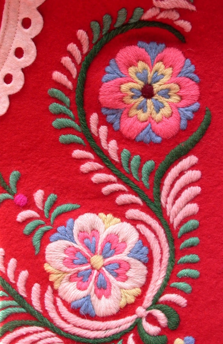 Love the thick satin embroidery over the dark red cloth.